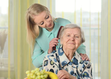 Caregiver coming a senior's hair